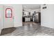 View of the dining area and kitchen with gray wood-look flooring and white cabinets at 1648 S Cole St # B7, Lakewood, CO 80228