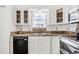 Bright kitchen boasts white cabinetry, stainless steel appliances, and tile countertops at 1648 S Cole St # B7, Lakewood, CO 80228