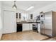Bright kitchen with white cabinetry, stainless steel appliances, and tile flooring at 1648 S Cole St # B7, Lakewood, CO 80228