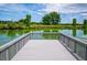 Wooden dock overlooking a calm lake in a peaceful park setting at 1648 S Cole St # B7, Lakewood, CO 80228