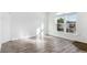 Living room with gray wood-look floors and a large window providing natural light at 1648 S Cole St # B7, Lakewood, CO 80228