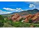 Scenic view of Red Rocks Amphitheatre with lush greenery and a winding road at 1648 S Cole St # B7, Lakewood, CO 80228