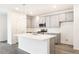 Stylish kitchen island with white quartz countertops and gray cabinets at 9310 Bahama Ct, Commerce City, CO 80022