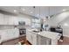 Open concept kitchen boasts white cabinets and stainless steel appliances at 2815 W 25Th Ave # 2, Denver, CO 80211