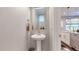 Small powder room with pedestal sink and mirror at 2815 W 25Th Ave # 2, Denver, CO 80211
