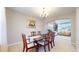 Formal dining room with wooden table, chandelier and adjacent living area at 5954 Star View Dr, Broomfield, CO 80020