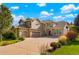 Two-story house with three-car garage, stone accents and landscaping at 5954 Star View Dr, Broomfield, CO 80020