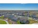 Aerial view of a new neighborhood with houses, landscaping, and a lake at 13610 Topaz Pl, Mead, CO 80504