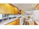 Kitchen features wood cabinets, gas range, and access to a hot tub at 131 Russel Gulch Rd, Central City, CO 80403
