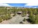 Aerial view of a rustic cabin nestled in a wooded mountain setting at 131 Russel Gulch Rd, Central City, CO 80403