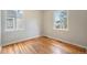 Well-lit bedroom featuring hardwood floors and ample natural light from two windows at 4636 Beach Ct, Denver, CO 80211