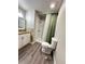 Clean bathroom with new flooring and shower/tub combo at 9737 Race St, Thornton, CO 80229