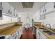 Kitchen with white cabinets, wood countertops, and a view into dining area at 920 S Walden Way Way # 103, Aurora, CO 80017