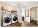 Convenient laundry room with washer, dryer, and storage shelves at 4888 Thorndike Ave, Castle Rock, CO 80104