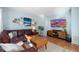 Spacious living room featuring a leather sectional sofa and large TV at 4888 Thorndike Ave, Castle Rock, CO 80104