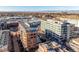 Wide aerial view of the building and its surroundings, including mountains in the distance at 100 Detroit St # 406, Denver, CO 80206