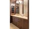 Double vanity bathroom with dark wood cabinets and granite countertop at 100 Detroit St # 406, Denver, CO 80206