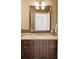 Small bathroom with single vanity and dark wood cabinets at 100 Detroit St # 406, Denver, CO 80206