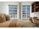 Bright bedroom with built-in shelves and city views at 100 Detroit St # 406, Denver, CO 80206