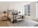 Spacious bedroom with large windows, plush bedding, and a sitting bench at 100 Detroit St # 406, Denver, CO 80206