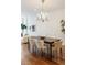 Elegant dining room with chandelier, hardwood floors, and seating for six at 100 Detroit St # 406, Denver, CO 80206