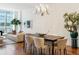 Bright dining room features a spacious table and elegant chandelier at 100 Detroit St # 406, Denver, CO 80206
