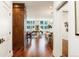 Elegant hallway with hardwood floors offering a view into the living and dining areas at 100 Detroit St # 406, Denver, CO 80206