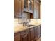Kitchen features granite counters, custom cabinetry, and a farmhouse sink at 100 Detroit St # 406, Denver, CO 80206
