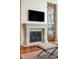 Living room fireplace with built-in cabinetry and wet bar at 100 Detroit St # 406, Denver, CO 80206