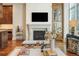 Living room features a fireplace, built-in shelving, and hardwood floors at 100 Detroit St # 406, Denver, CO 80206