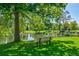 Serene pond and lush green space with a bench for relaxation at 13781 E Marina Dr # B, Aurora, CO 80014