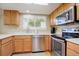 Kitchen with stainless steel appliances and light wood cabinets, offering ample counter space at 652 Mountain Chickadee Rd, Highlands Ranch, CO 80126