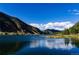Stunning mountain lake view with clear blue water and dramatic sky at 2121 Hummingbird Way # 103, Georgetown, CO 80444