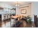 Bright dining area with hardwood floors, a rustic wood table, and leather chairs at 1854 Jules Ln, Louisville, CO 80027