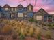 Stunning townhome exterior at dusk, featuring a charming architectural design and landscaping at 1854 Jules Ln, Louisville, CO 80027