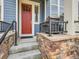 Front entrance with red door and stone accents at 1854 Jules Ln, Louisville, CO 80027