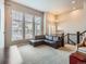 Living room featuring a sectional sofa, ample natural light, and a view of the staircase at 1854 Jules Ln, Louisville, CO 80027