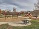 Community playground with swings, slides, and picnic tables at 1854 Jules Ln, Louisville, CO 80027