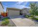 Ranch style home with attached two-car garage and landscaped yard at 4238 S Netherland Cir, Aurora, CO 80013