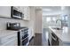 Modern kitchen with white cabinets, stainless steel appliances, and island at 4238 S Netherland Cir, Aurora, CO 80013