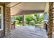 Covered porch with stone pillars and a view of the backyard at 16628 E 106Th Dr, Commerce City, CO 80022