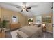 Cozy bedroom with ceiling fan and ample natural light at 252 S Owens St, Byers, CO 80103