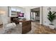Bright home office features a desk, chair, and view into living area at 495 S Dayton St # 10C, Denver, CO 80247
