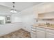 Simple kitchen featuring white cabinets and light countertops at 495 S Dayton St # 10C, Denver, CO 80247