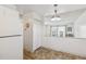White kitchen with breakfast bar and tile floor at 495 S Dayton St # 10C, Denver, CO 80247