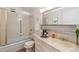 Clean bathroom with a tub, shower, and updated vanity at 495 S Dayton St # 10C, Denver, CO 80247