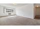 Bright living room with large window and neutral carpeting at 495 S Dayton St # 10C, Denver, CO 80247