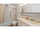 Clean bathroom with a tub, shower, and updated vanity at 495 S Dayton St # 10C, Denver, CO 80247