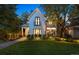 Stunning two-story farmhouse with landscaped yard and outdoor lighting at 2410 S Fillmore St, Denver, CO 80210