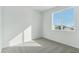 Well-lit bedroom featuring grey carpet and a window at 8683 Snake River St, Littleton, CO 80125